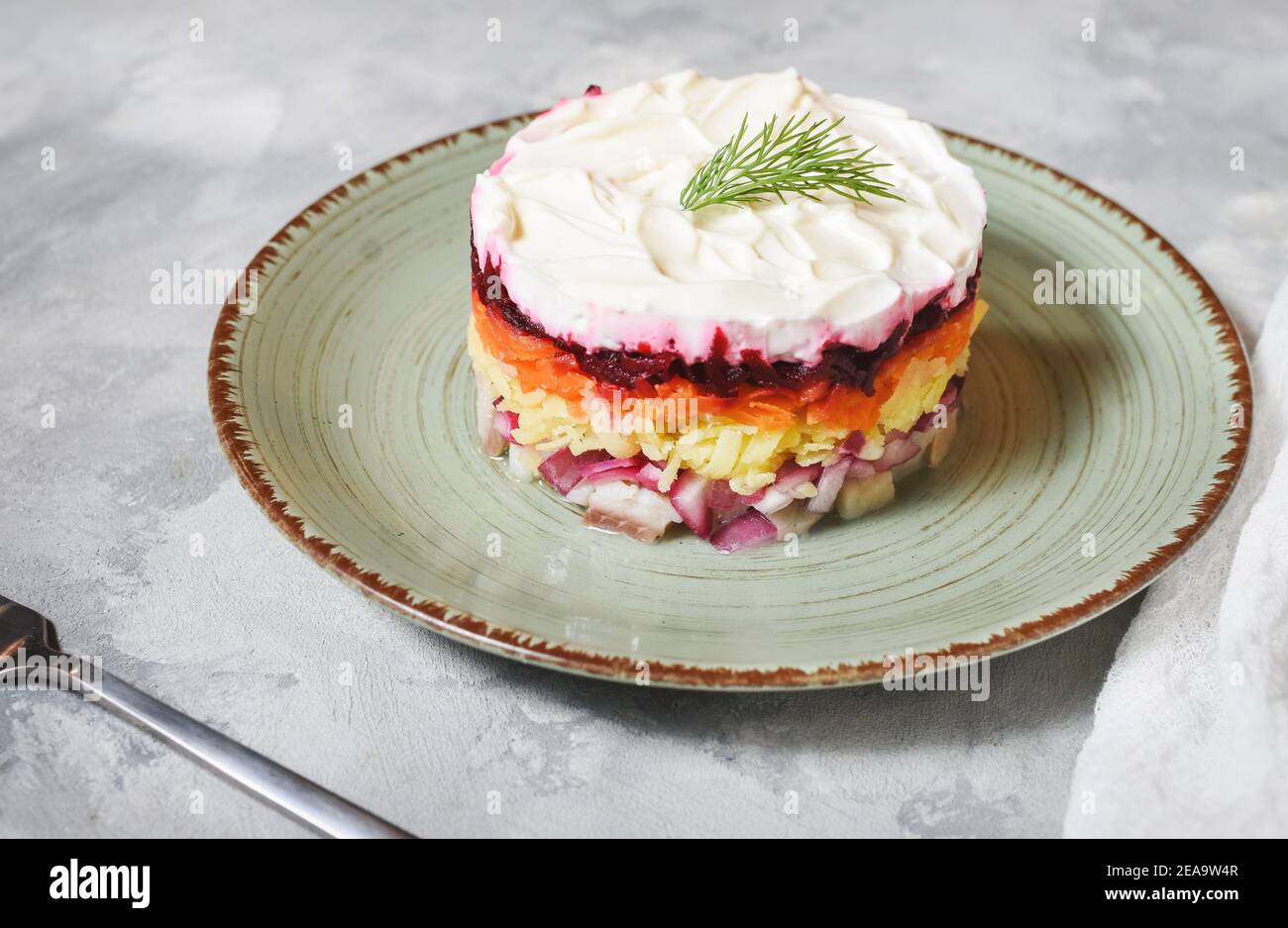 Russian traditional new year salad herring under fur coat on rustic concrete table Stock Photo