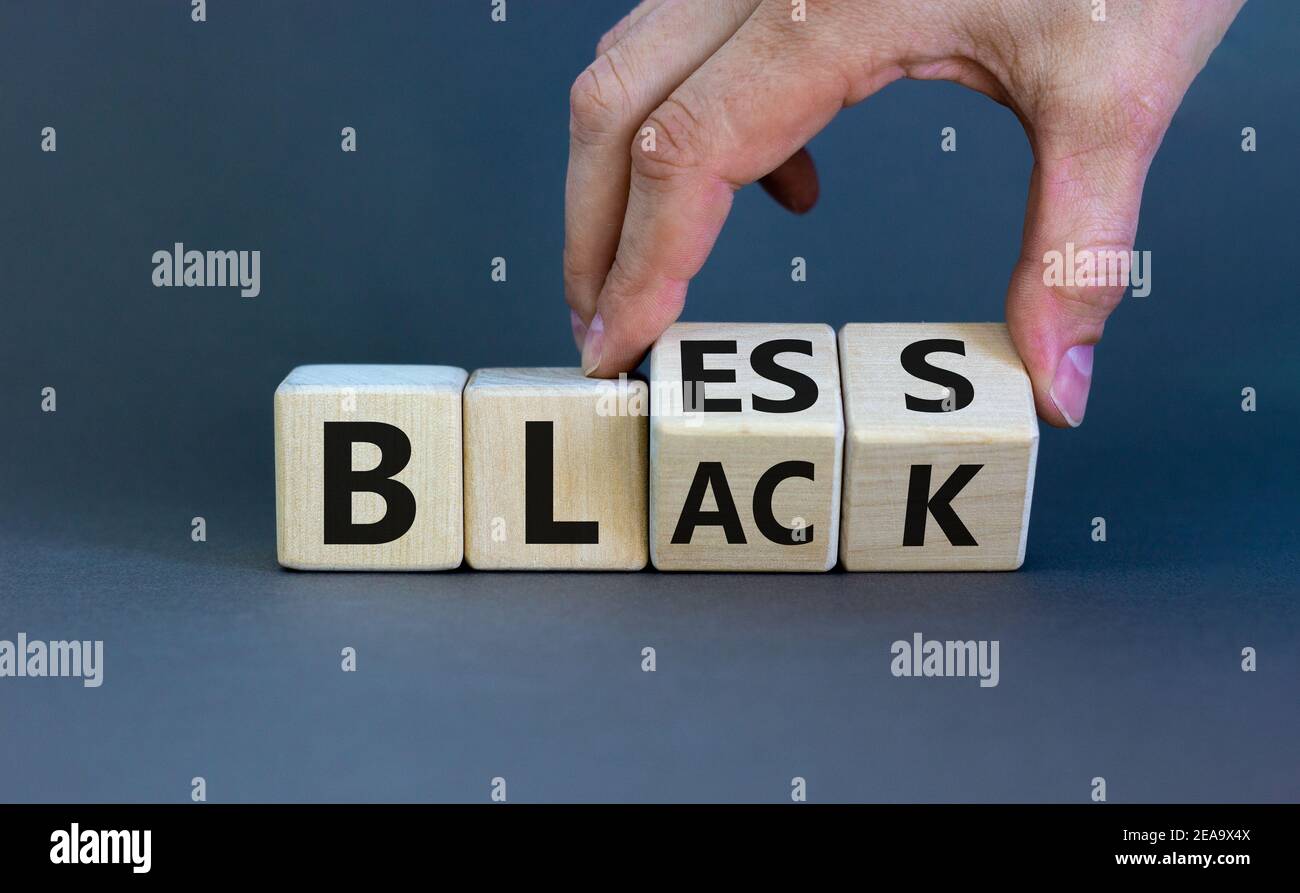 Bless black symbol. Hand flips a cube and changes the word 'black' to ...