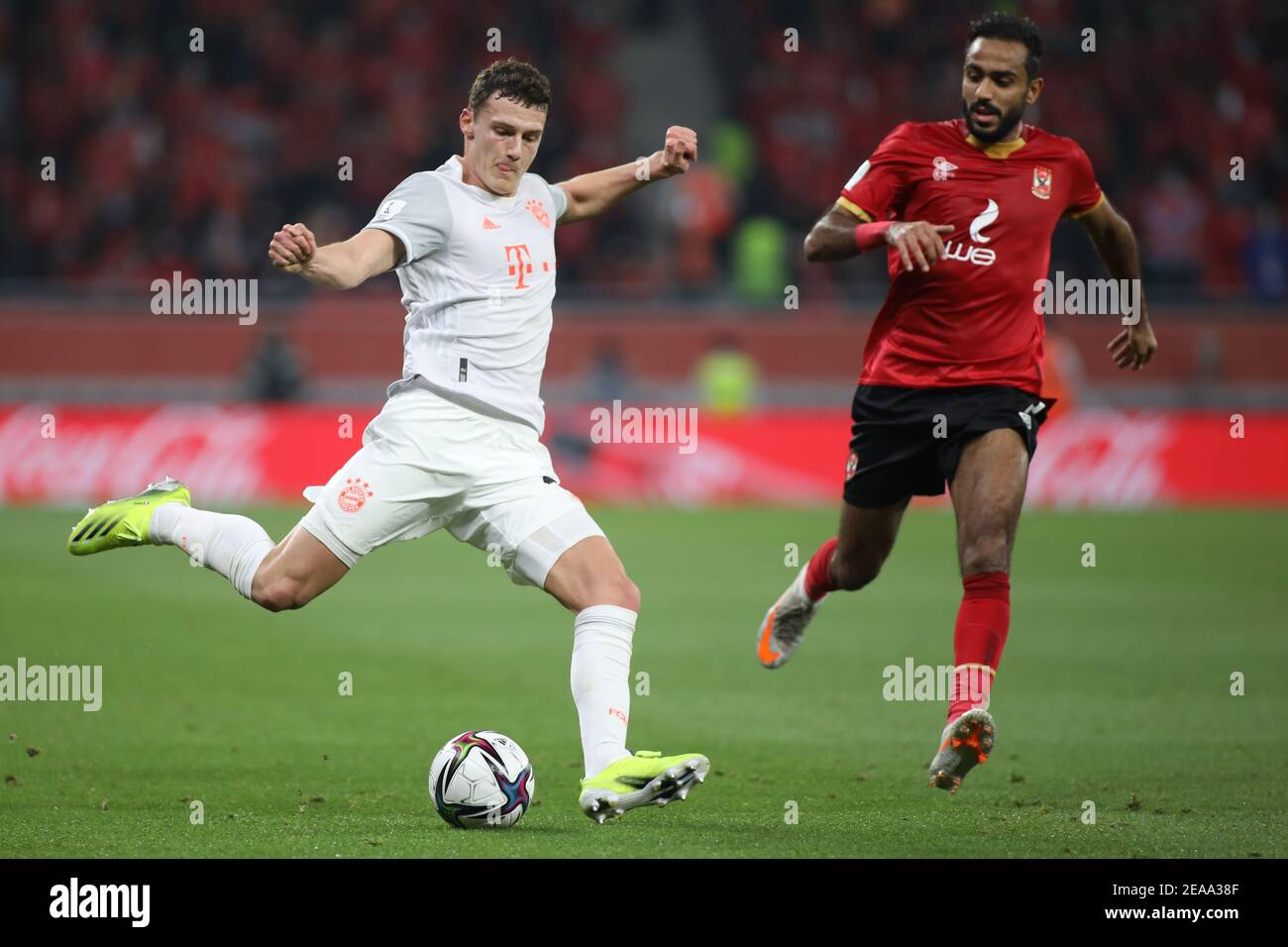 DOHA, QATAR - FEBRUARY 08: Kahraba of Al Ahly SX closes in on Benjamin Pavard of FC Bayern Muenchen as he crosses the ball into the box during the semi-final match between Al Ahly SC and FC Bayern Muenchen at Ahmad Bin Ali Stadium on February 8, 2021 in Doha, Qatar. (Photo by Colin McPhedran/MB Media) Stock Photo