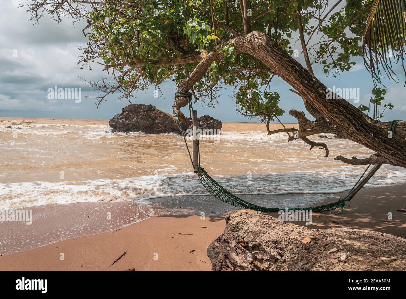 An abandoned hammock on an empty beach in Axim Ghana West Africa. Stock Photo