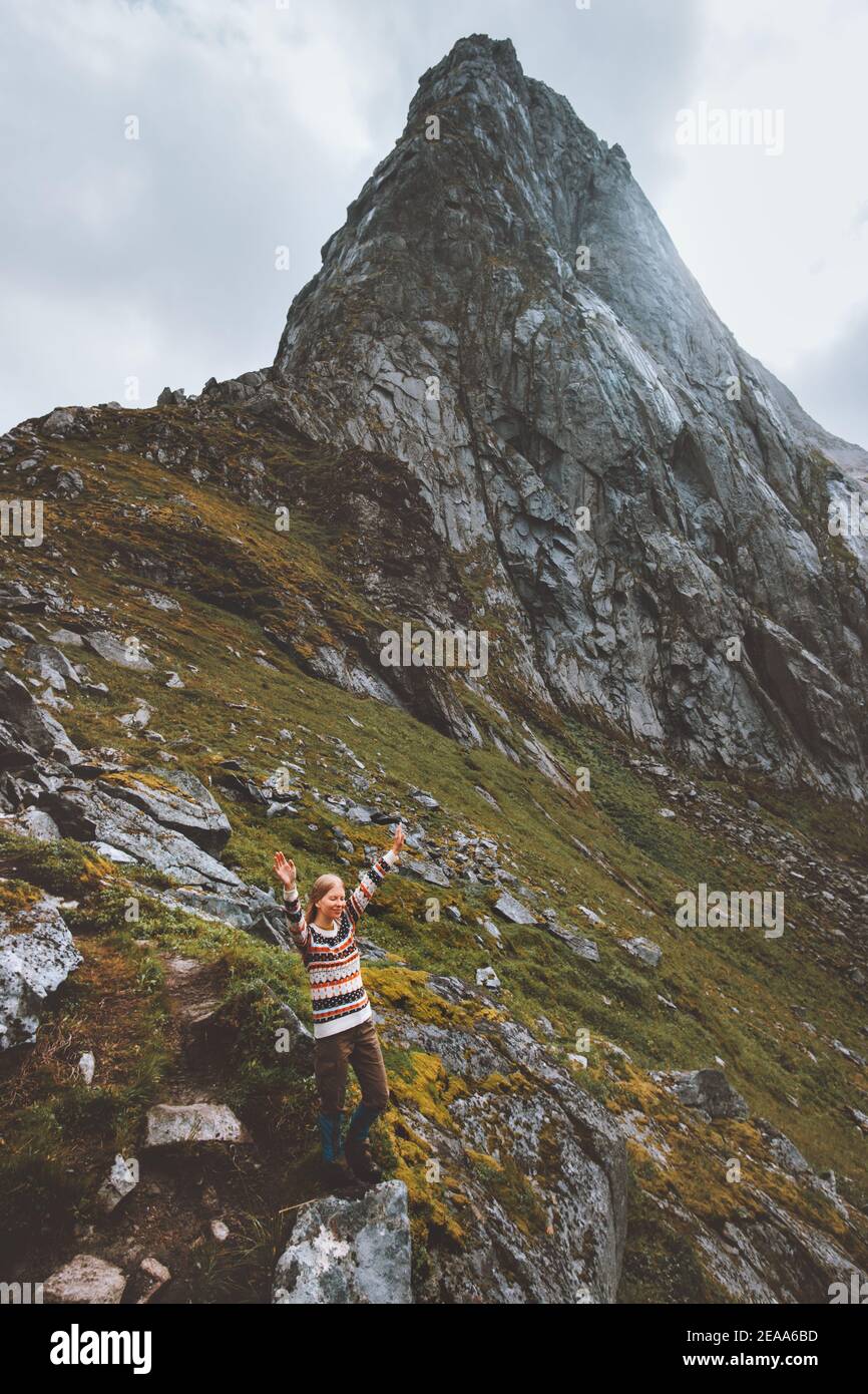 Woman raised hands enjoying mountain landscape travel hiking alone in Norway outdoor adventure active healthy lifestyle Stock Photo