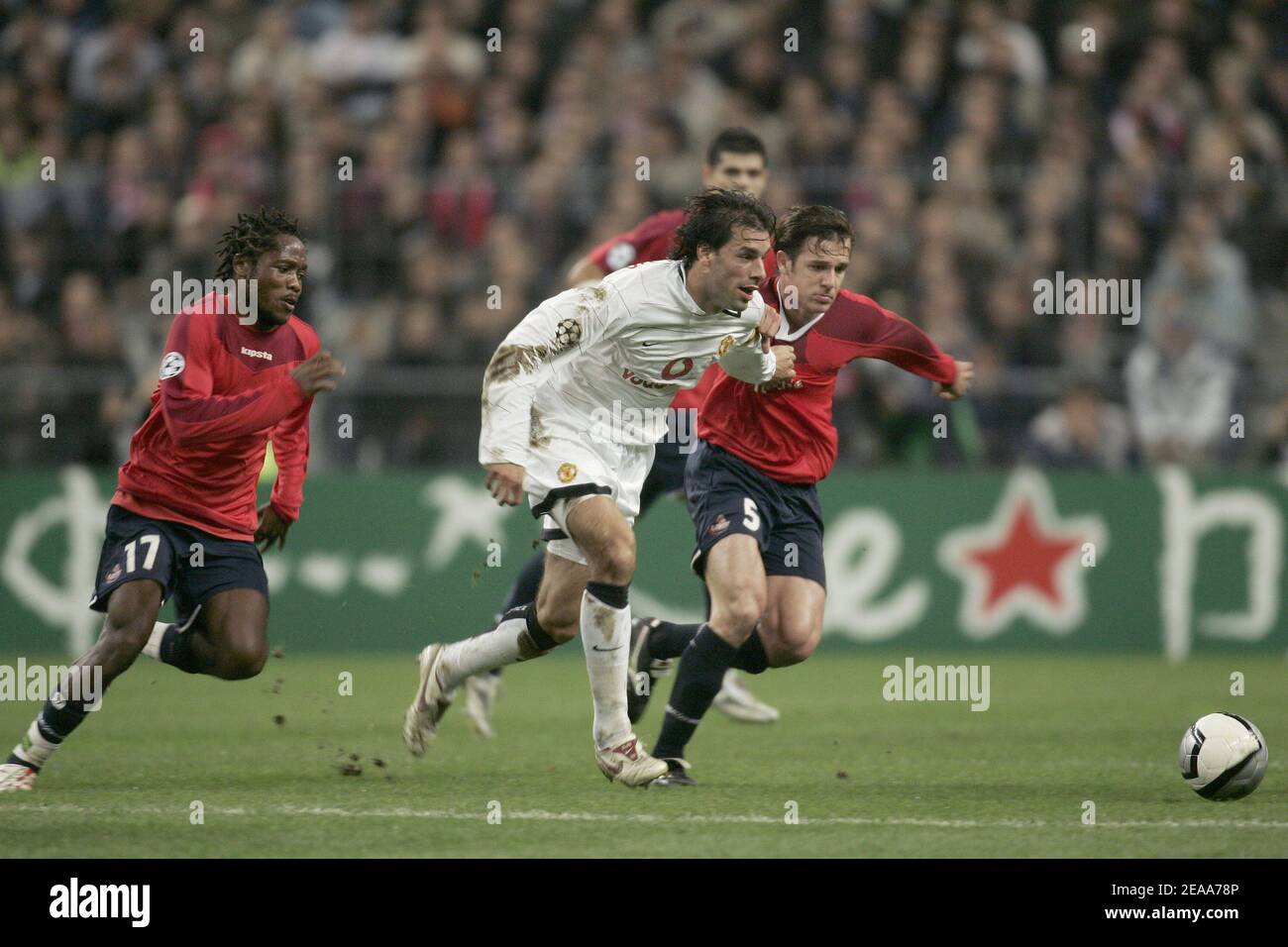 Manchester's Ruud Van Nistelrooy clears the ball under pressure from Lille's Jean Makoun(l) and Rafael (r) during the UEFA Champions League, Lille vs Manchester, in Saint-Denis near Paris, France, on November 2, 2005. Lille won 1-0. Photo by Laurent Zabulon/ABACAPRESS.COM Stock Photo