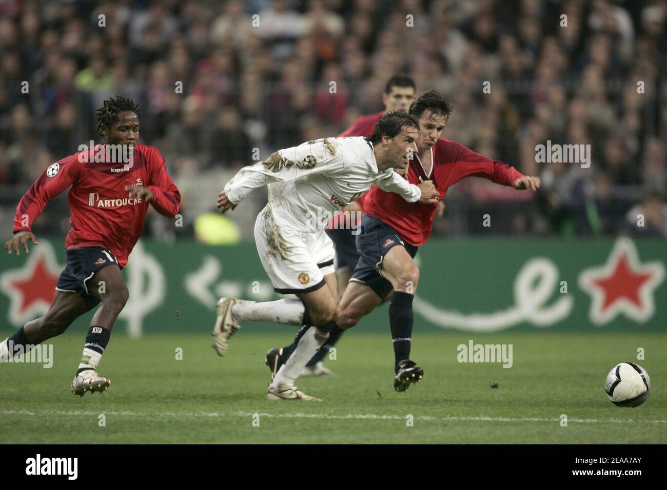 Manchester's Ruud Van Nistelrooy clears the ball under pressure from Lille's Jean Makoun(l) and Rafael (r) during the UEFA Champions League, Lille vs Manchester, in Saint-Denis near Paris, France, on November 2, 2005. Lille won 1-0. Photo by Laurent Zabulon/ABACAPRESS.COM Stock Photo