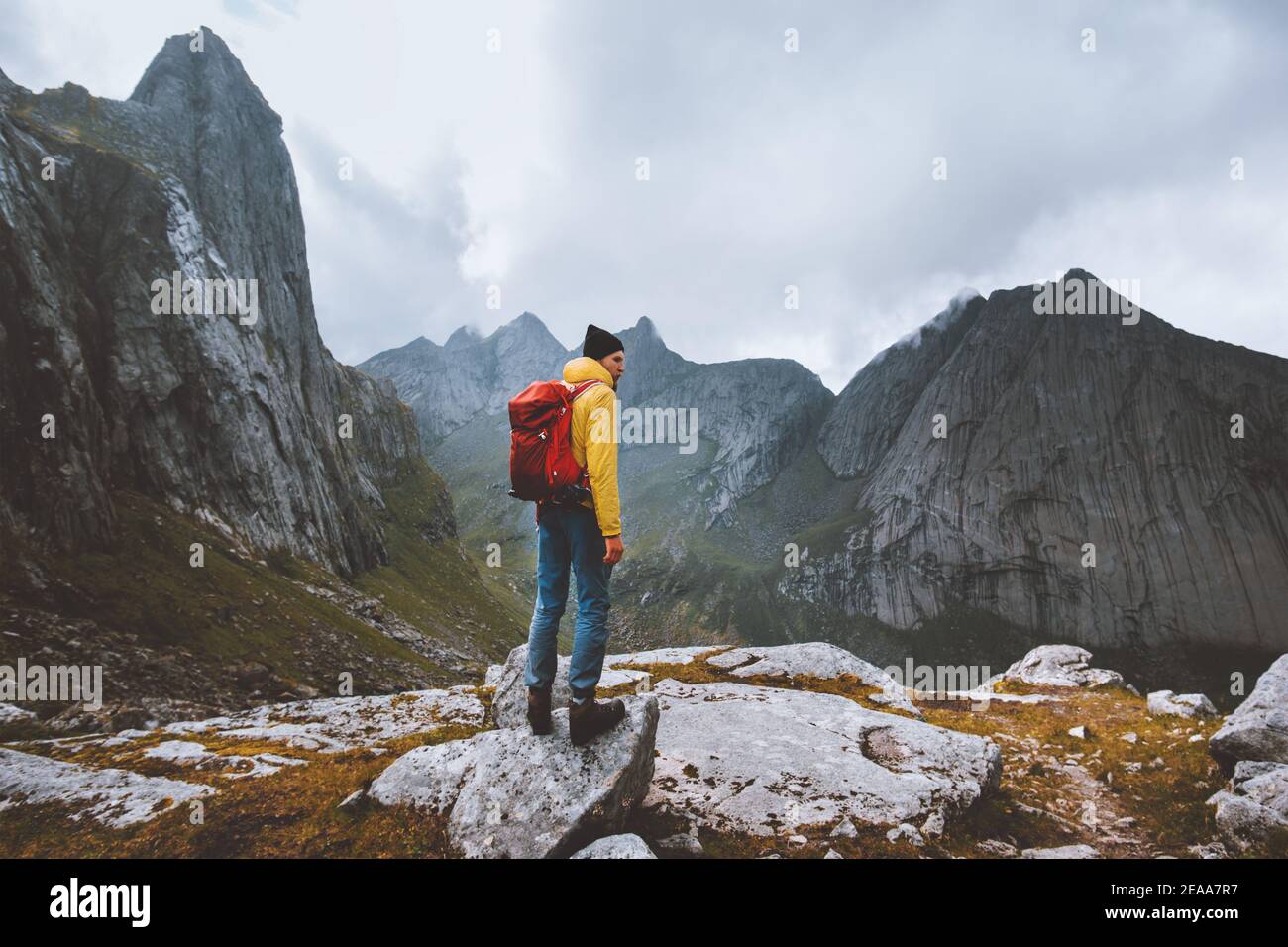 Man with backpack hiking solo in Norway mountains travel vacations outdoor adventure trekking active healthy lifestyle weekend getaway Stock Photo
