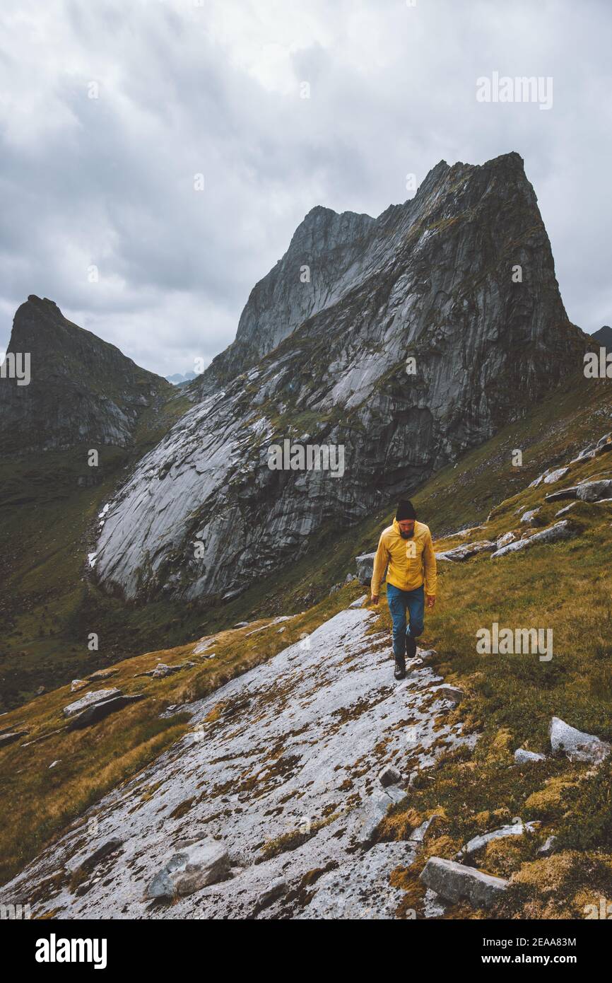 Man hiking alone in mountains Norway travel adventure active vacation healthy lifestyle survival explore wilderness Stock Photo