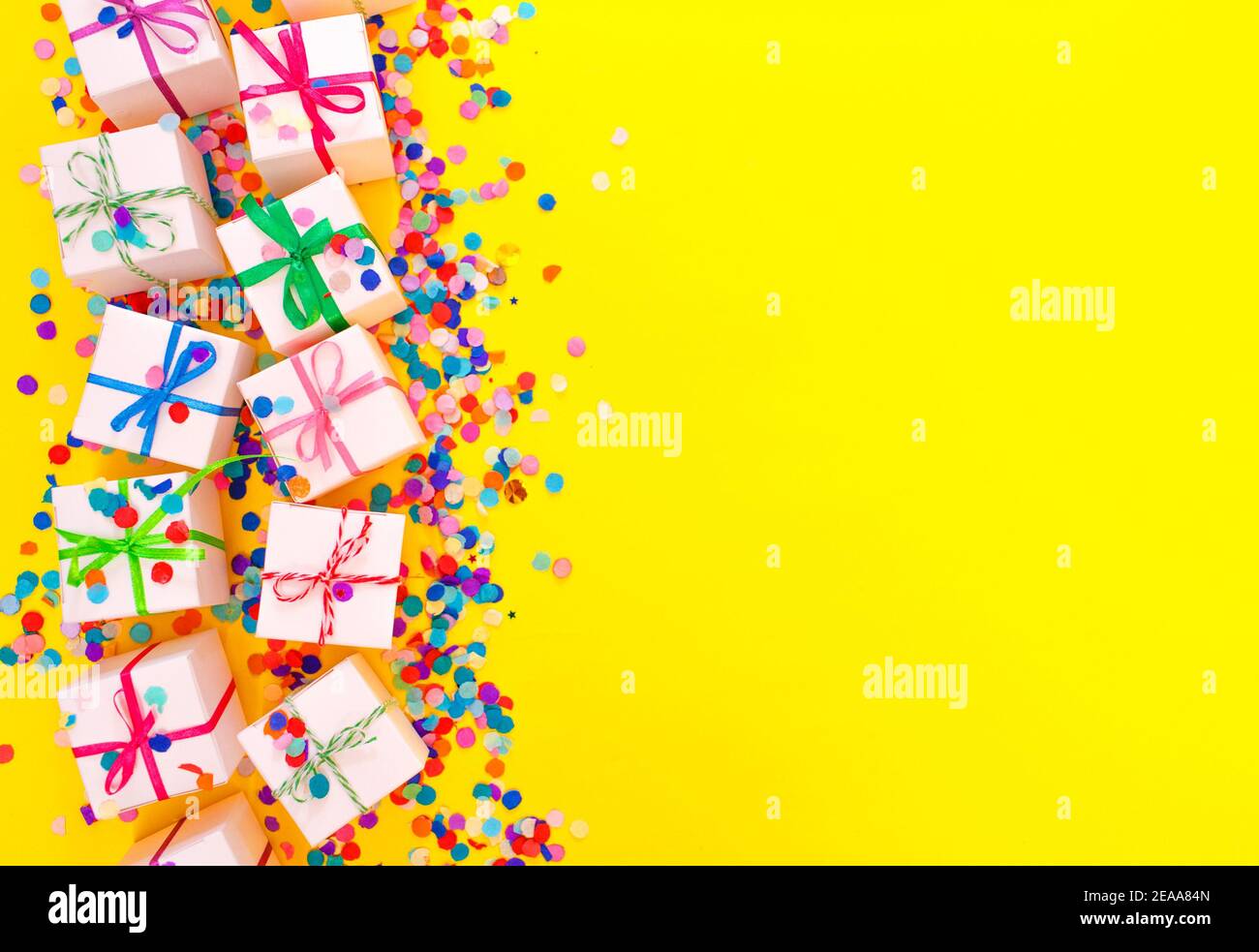colorful gift boxes on a yellow background top view. Stock Photo
