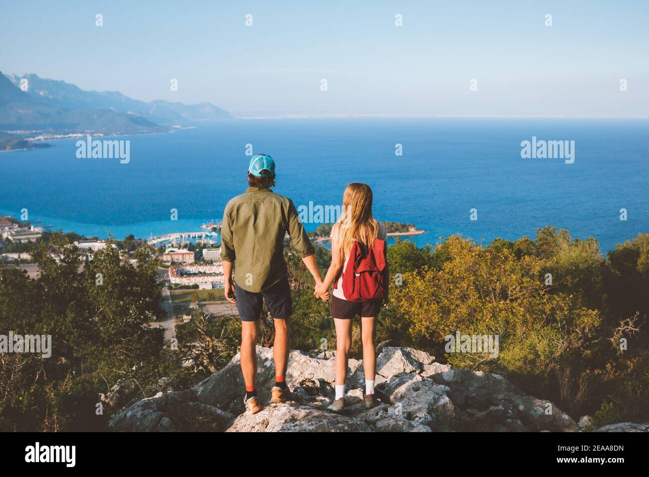 Couple in love man and woman holding hands on mountain top friends traveling together in Turkey enjoying view vacation trip lifestyle outdoor mediterr Stock Photo