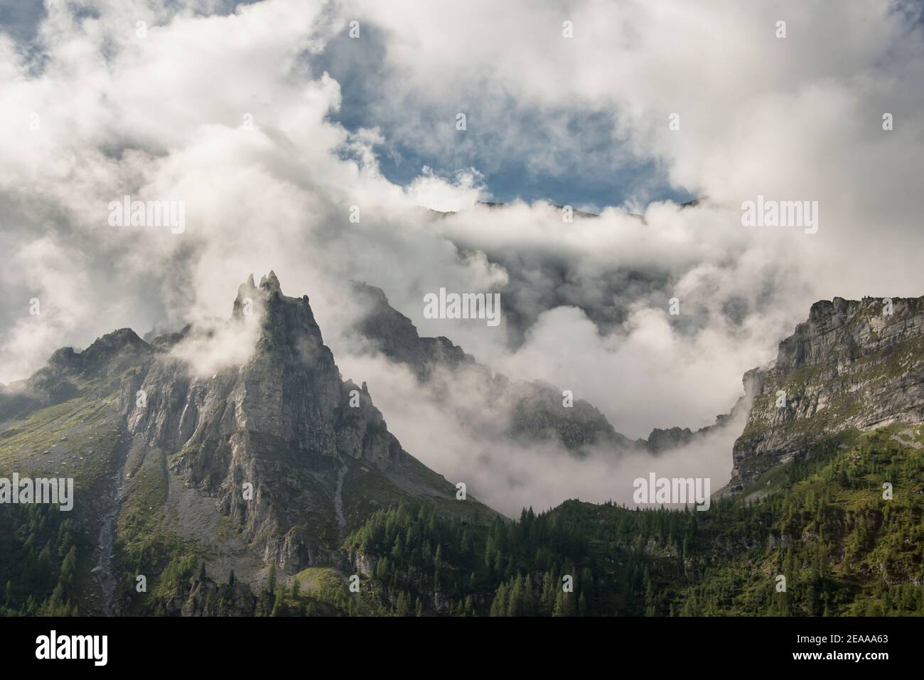 Cloud-covered mountain peaks Stock Photo