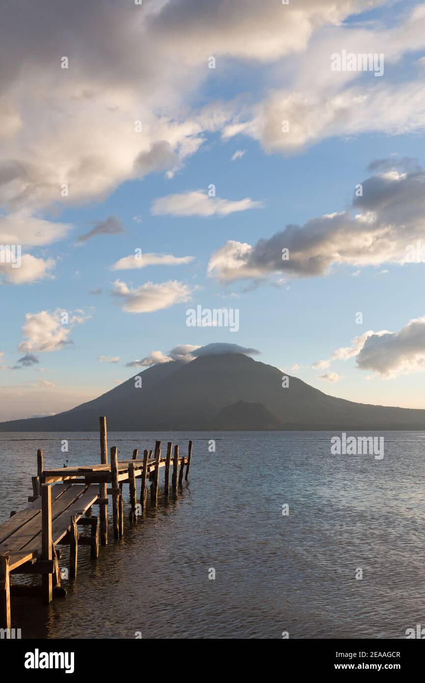Panajachel, Lake Atitlan, Guatemala Dock jutting into lake Atitlan with Toliman Volcano, Antigua Volcano, Stock Photo