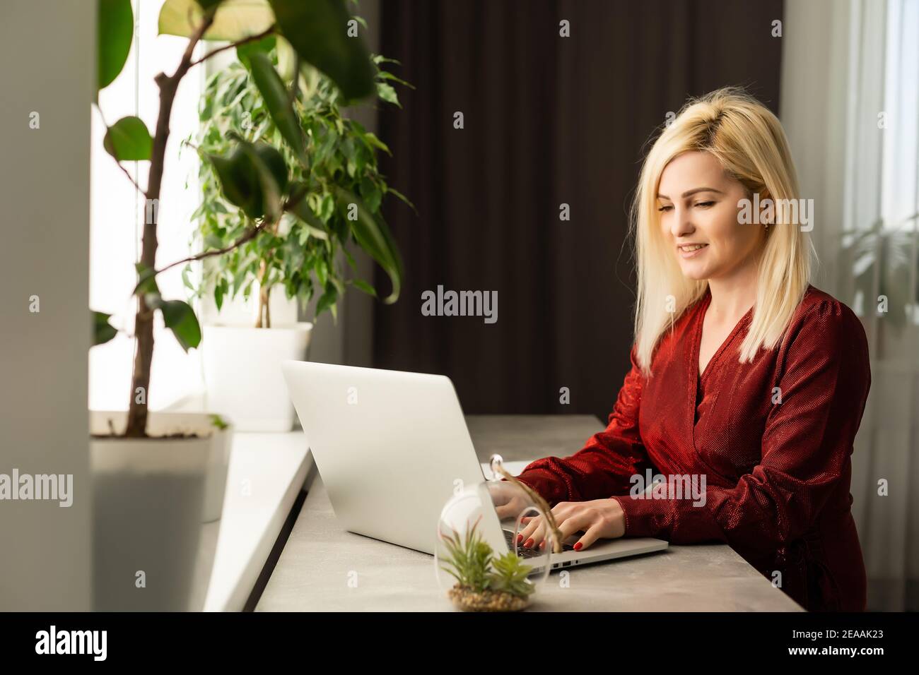 Beautiful young woman working on her laptop in her office Stock Photo ...