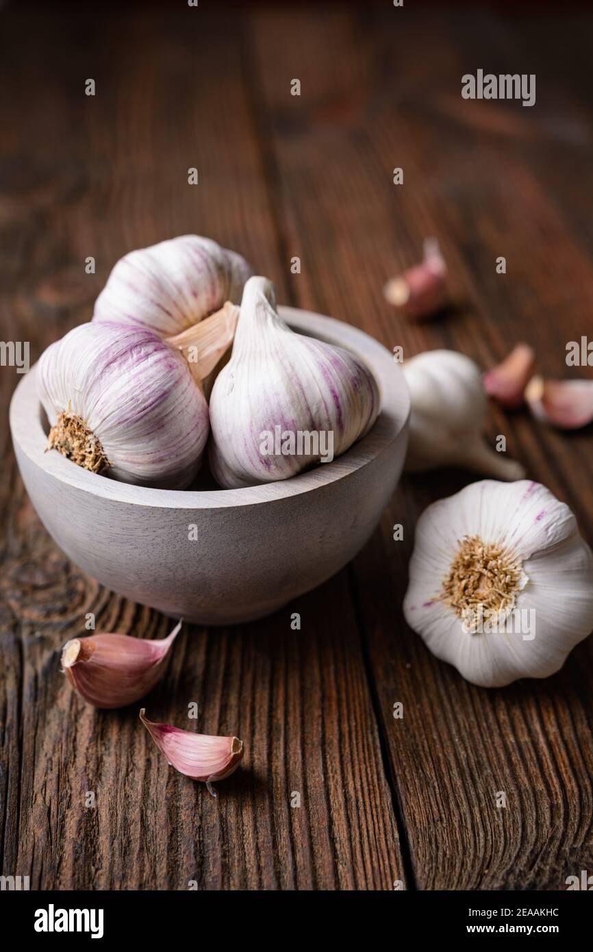 Natural antibiotic, fresh garlic bulbs with cloves on rustic wooden