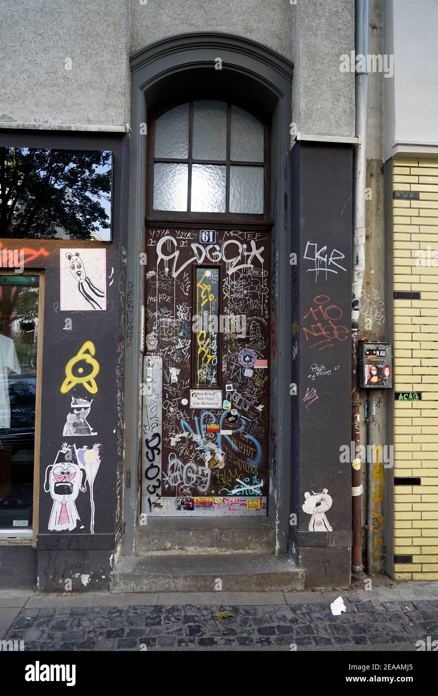 Germany, North Rhine-Westphalia, Cologne, old residential building, front door, defaced with writings, signs, graffiti Stock Photo