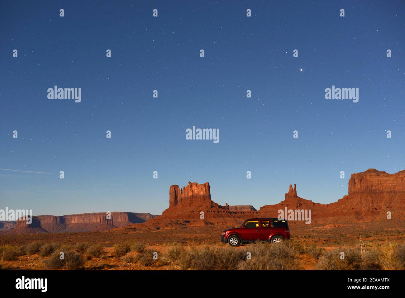 Camping in a SUV at Monument Valley Utah under a starry sky.  Stock Photo