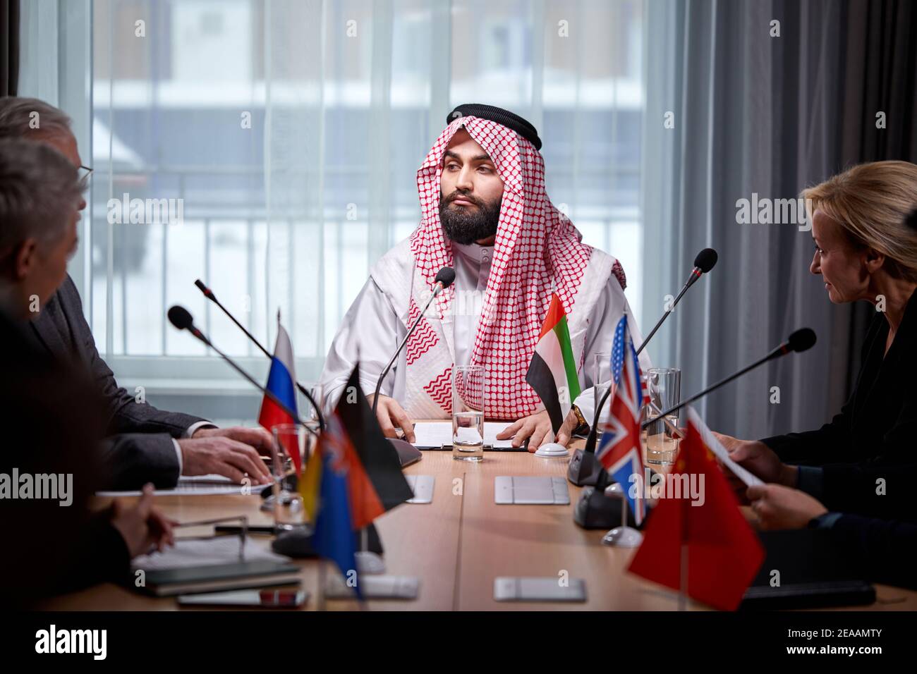 sheikh man presenting his ideas to colleagues and listening for ideas ...