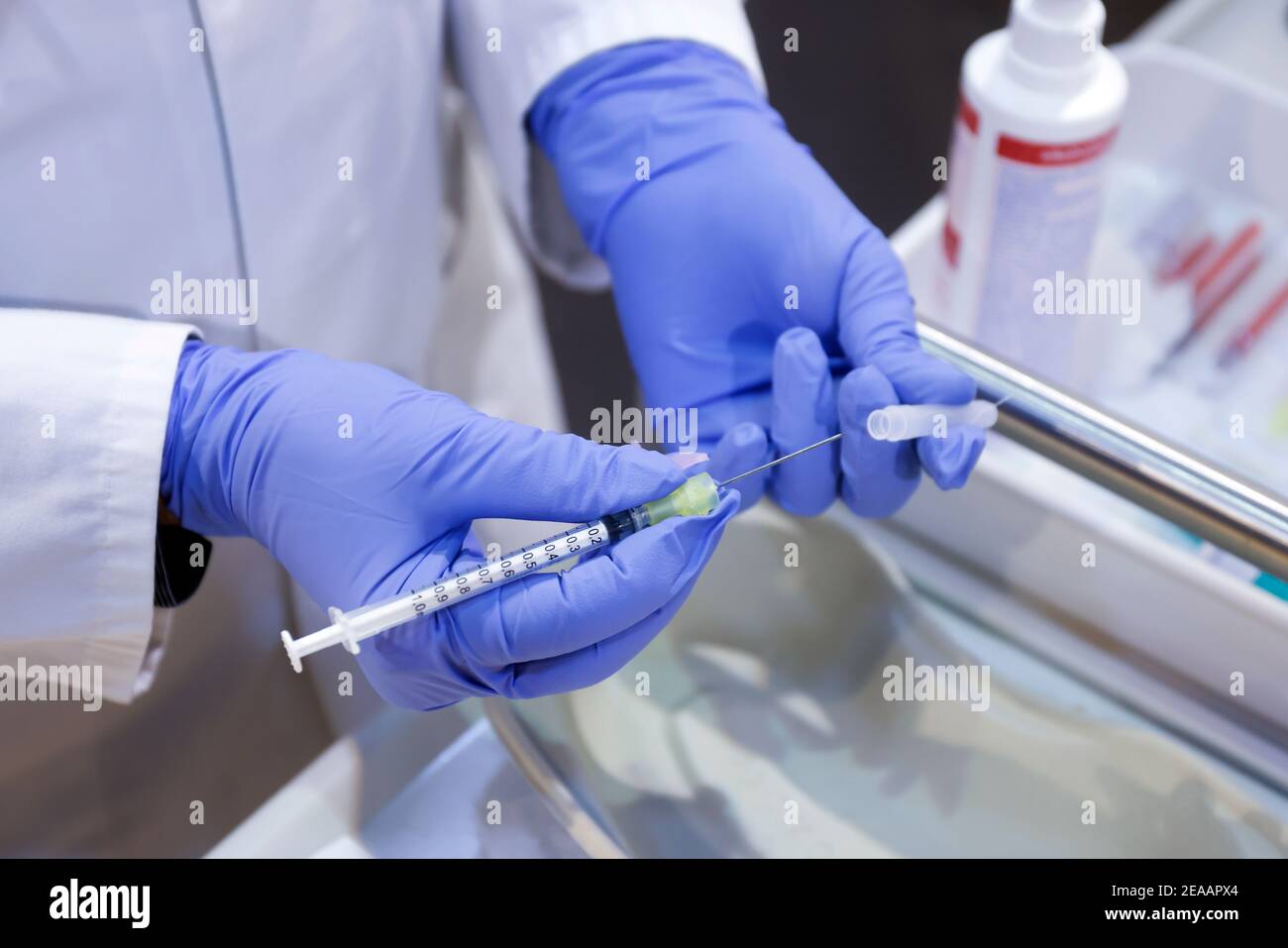 Essen, Ruhr area, North Rhine-Westphalia, Germany - Corona vaccination center Essen in the halls of Messe Essen, here more than 2, 000 people are to be vaccinated per day, during a test run a doctor prepares an injection syringe (scene posed) Stock Photo