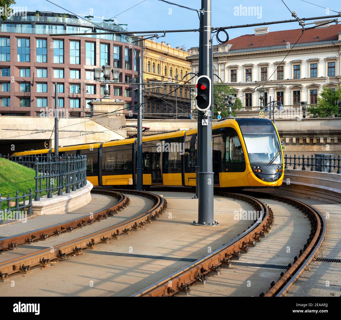 Modern yellow tram driving out of the tunnel in Budapest Stock Photo