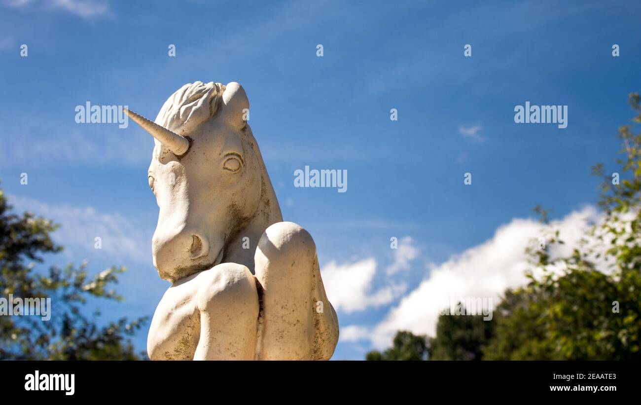 Unicorn Statue in Garden Rearing Up Stock Photo