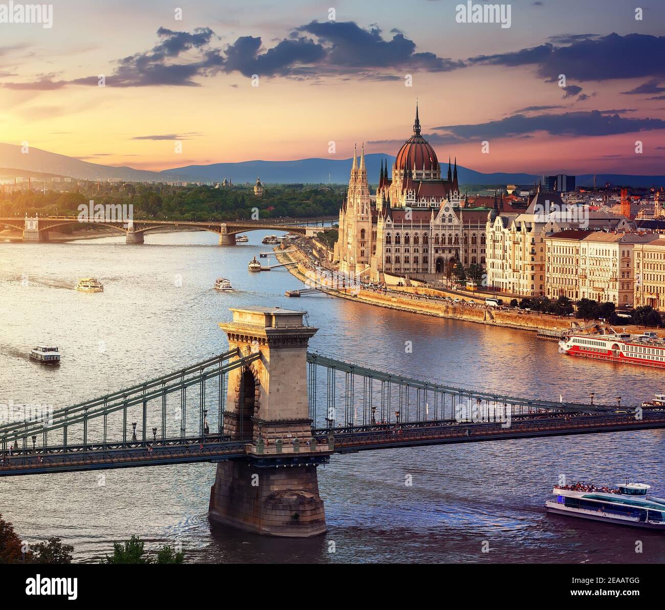Parliament and famous bridges of Budapest at sunset, Hungary Stock Photo