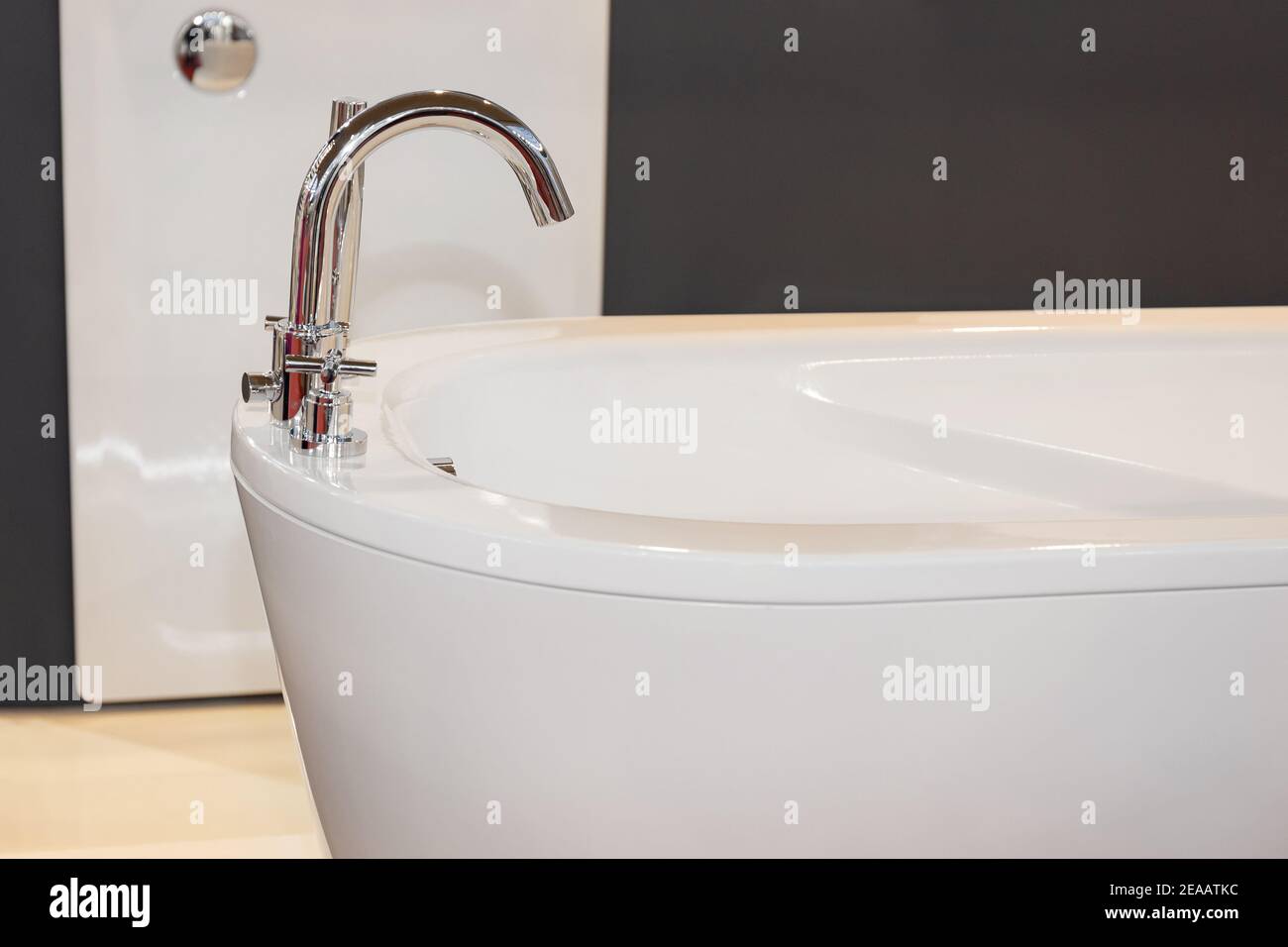 Modern Faucet Controls at Oval Shape Stand Alone Bathtub Stock Photo
