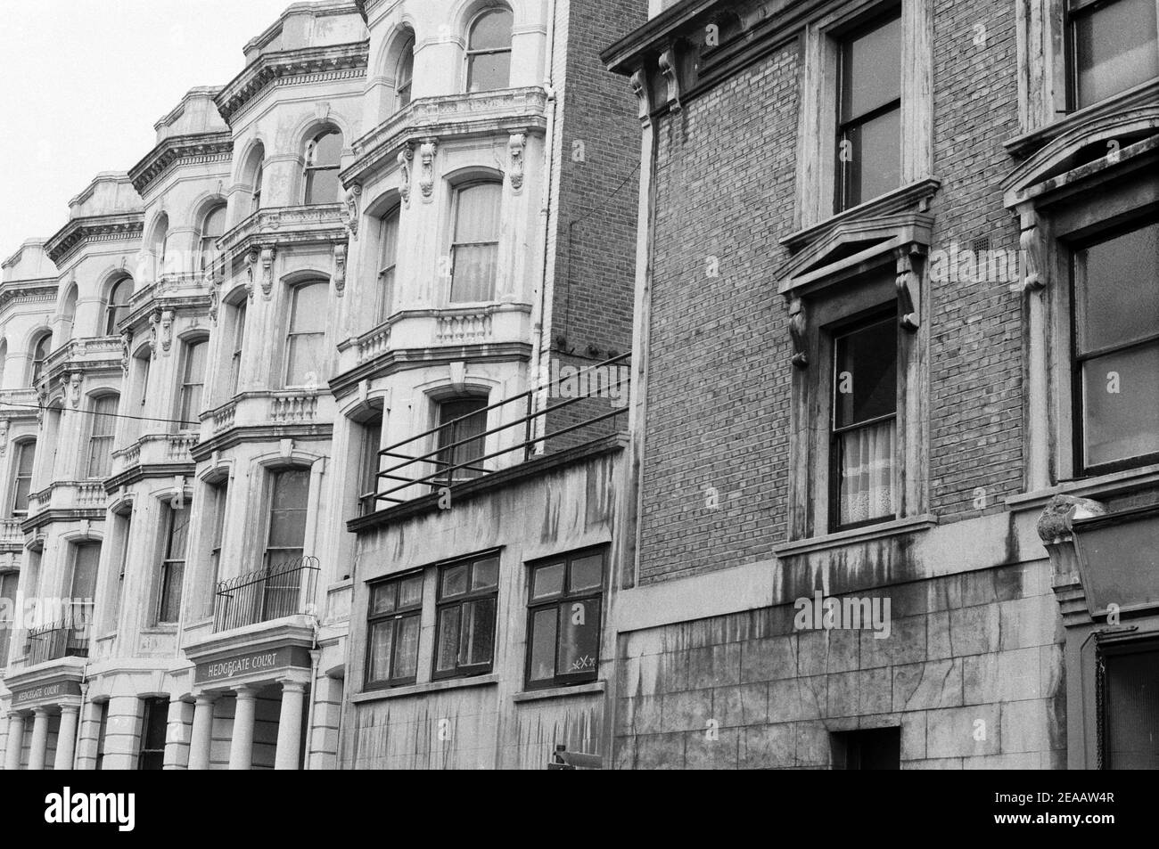 UK, West London, Notting Hill, 1973. Rundown & dilapidated large four-story houses are starting to be restored and redecorated. No. 1-3 Powis Terrace, Hedgegate Court, near Talbot Road junction. Stock Photo