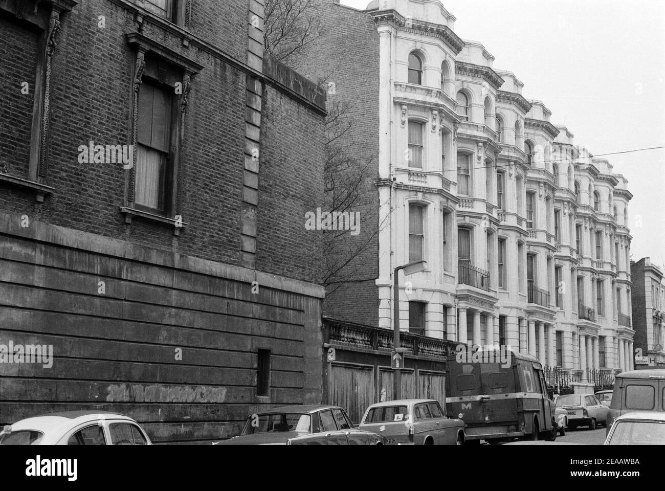 UK, West London, Notting Hill, 1973. Rundown & dilapidated large four-story houses are starting to be restored and redecorated. Powis Terrace, No. 2-4 Hedgegate Court. Near corner with Talbot Road (left). Stock Photo