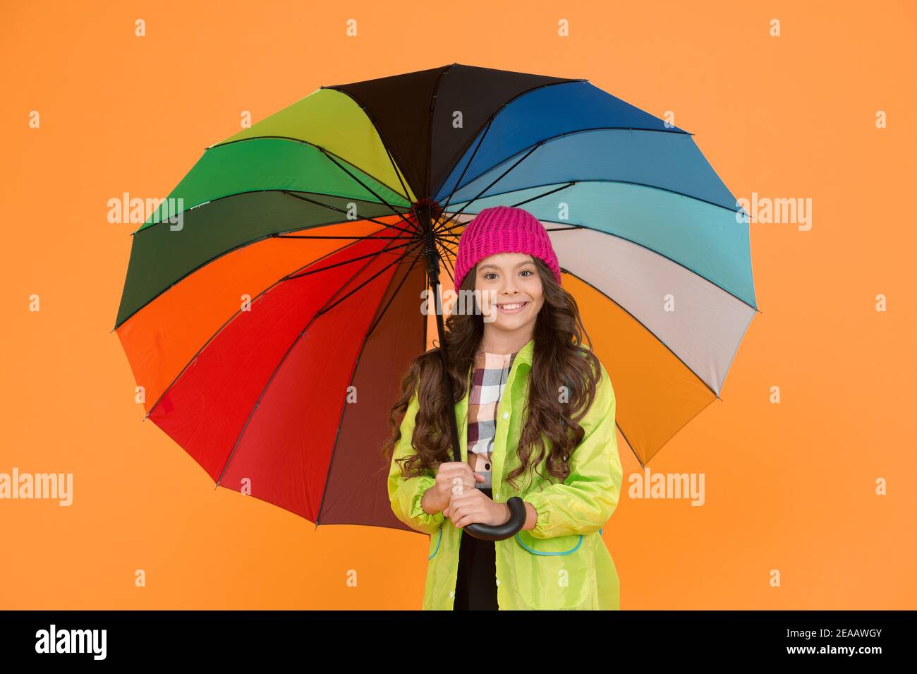 Umbrella cant stop rain. Happy small child in raincoat carry umbrella against rain. Cute little