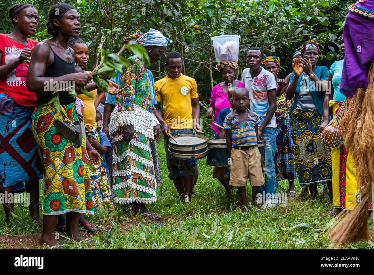 Mende People dancing in Western Area Rural, Sierra Leone. The men of the village drum the dominant rhythms. Also the offspring is already there Stock Photo