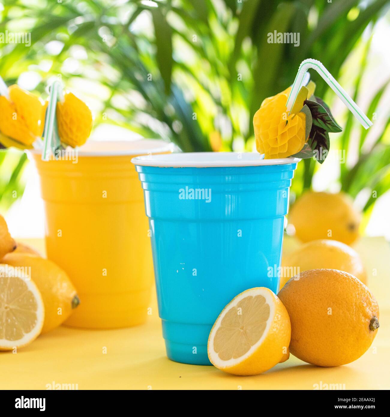 Colourful yellow and blue cups with lemons and straws Stock Photo Alamy