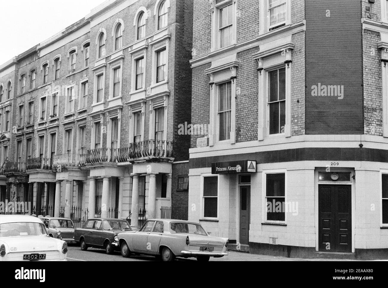 UK, West London, Notting Hill, 1973. Rundown & dilapidated large four-story houses are starting to be restored and redecorated. Princess Alexandra pub on Ledbury Road (No.209) and corner of Westbourne Park Road. This is now a restaurant. Stock Photo
