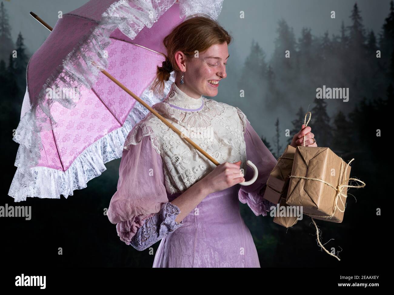 Woman, parasol, gifts, pink vintage dress Stock Photo