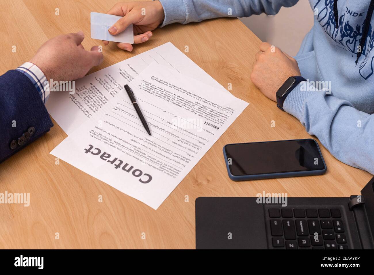 Selective focus of a young man giving documentation to the bank or notary to execute a contract in the office of the company director. Stock Photo