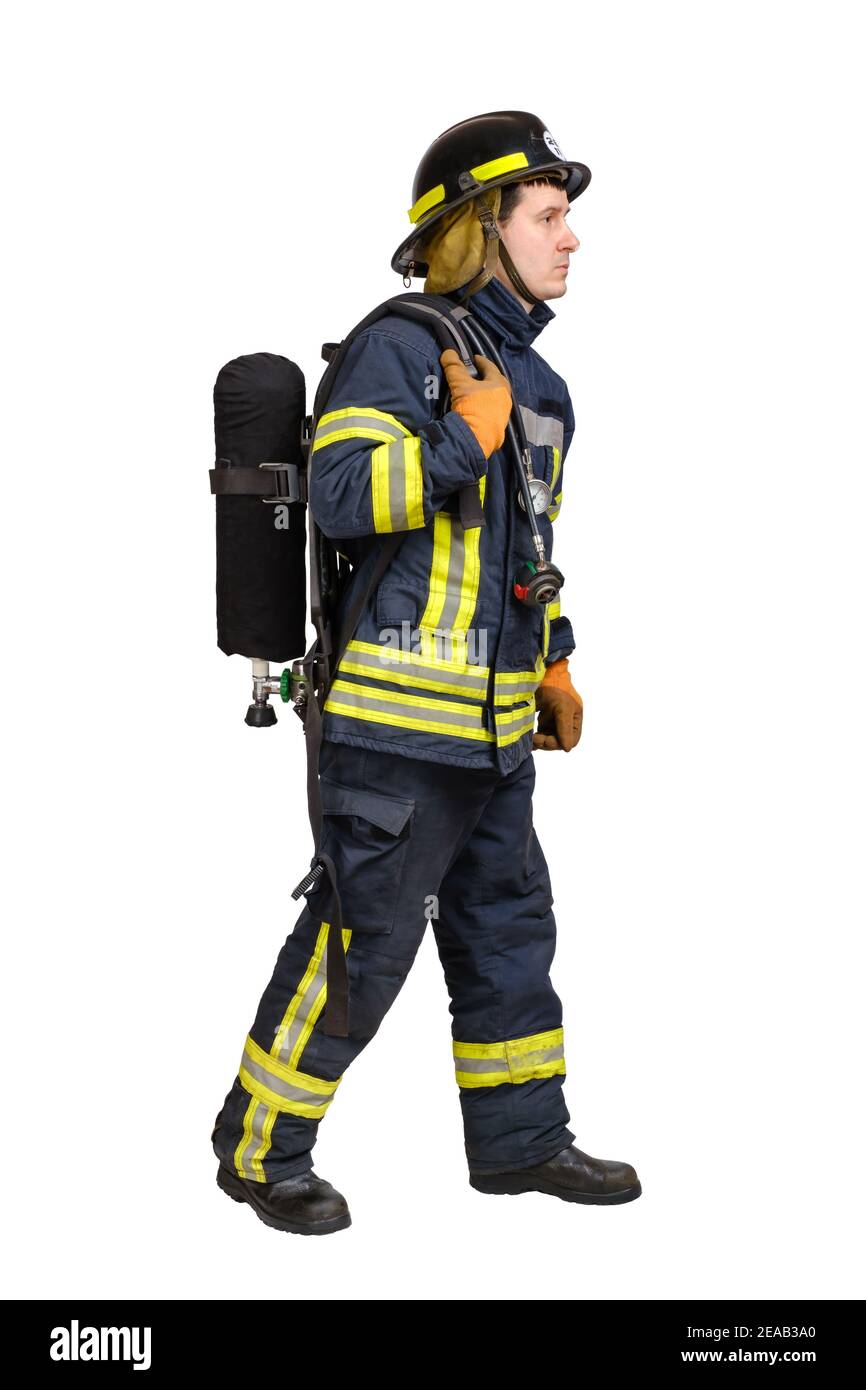 man in uniform of firefighter posing in profile with air tank Stock Photo