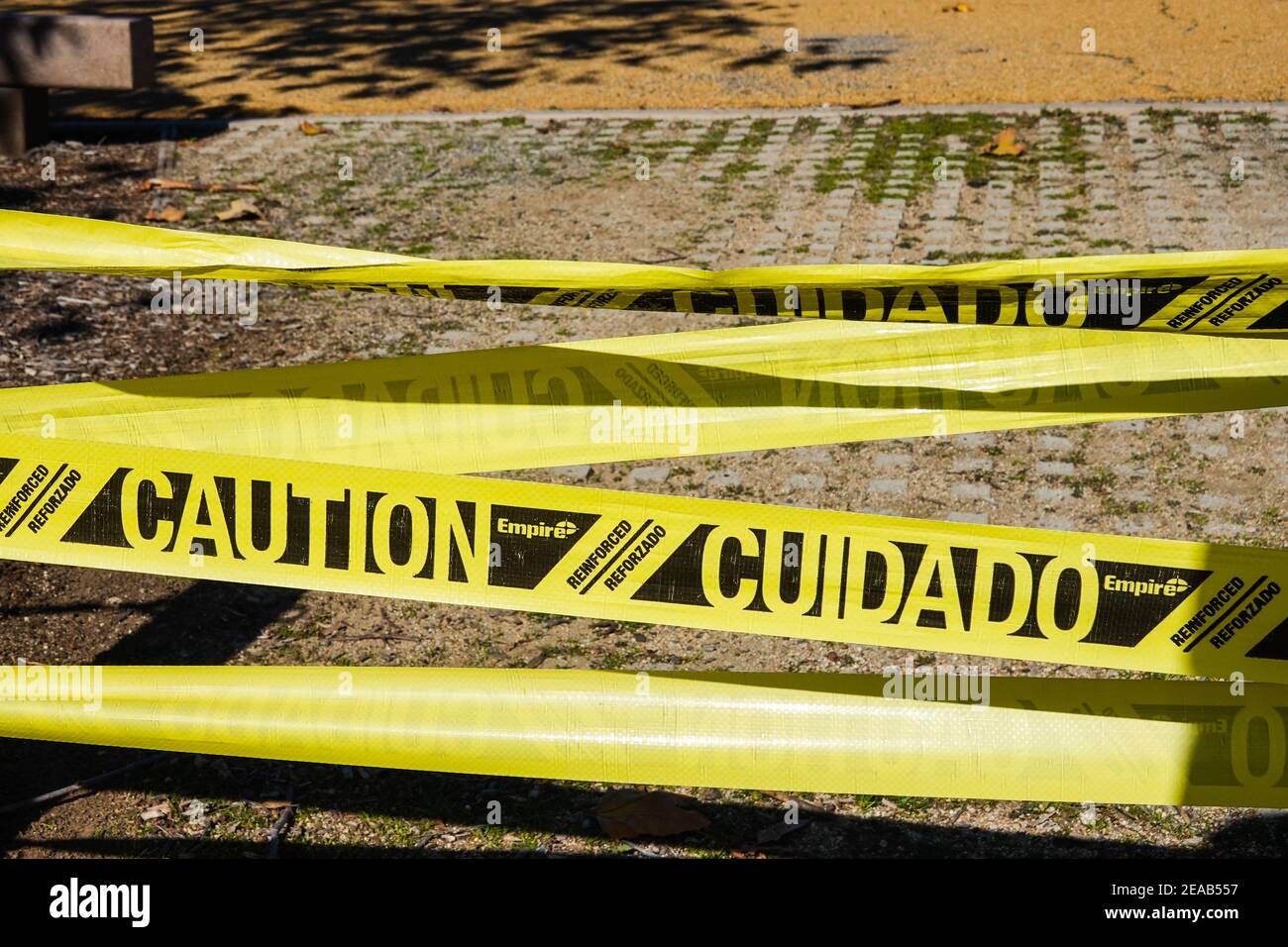 Yellow caution tape in Mexican / Spanish (cuidado) and English Stock