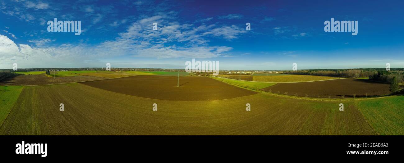 Beautiful summer aerial panorama landscape over fields and green meadows, while the sun is shining. Stock Photo