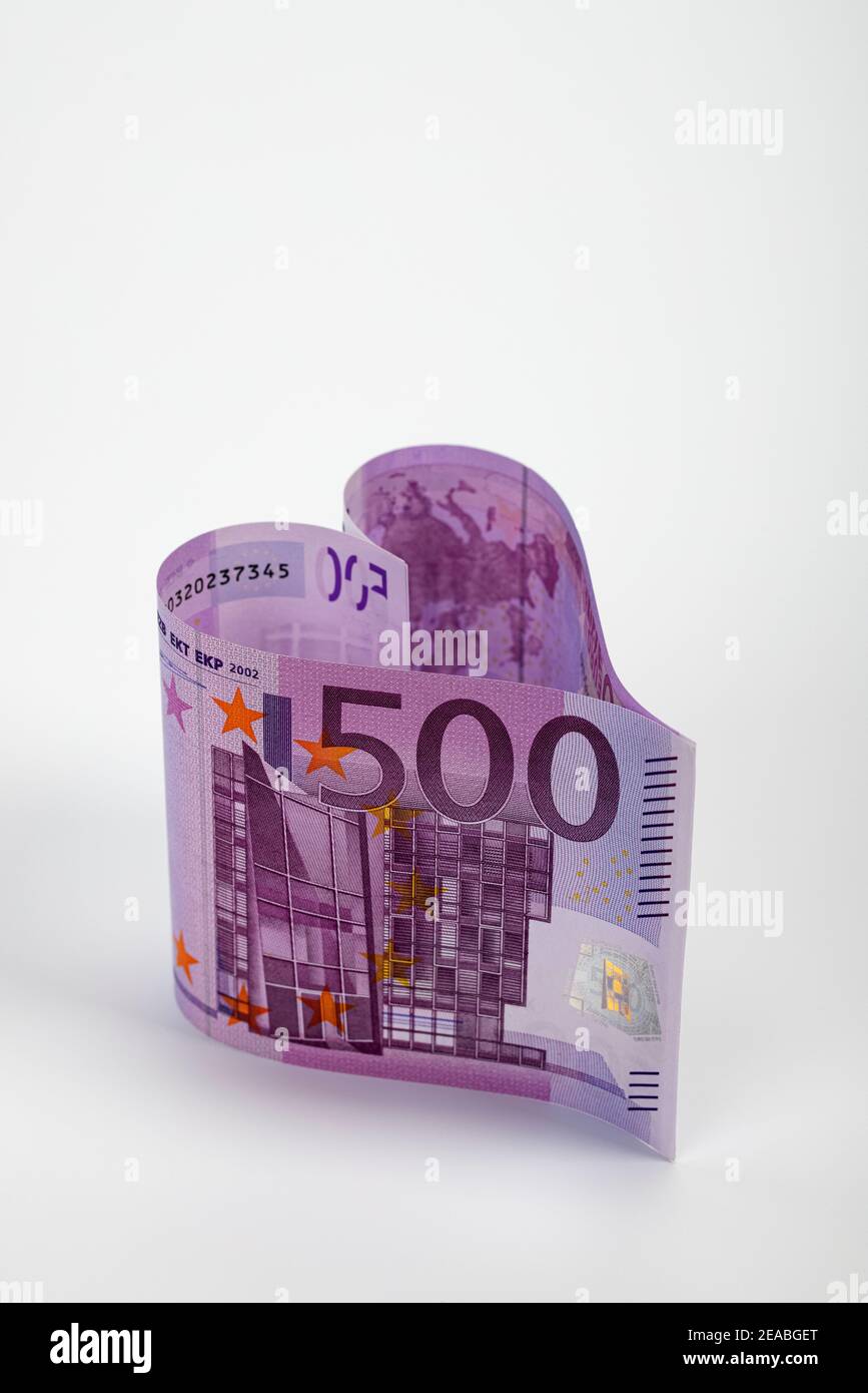 Two 500 euro banknotes in the shape of a heart, symbolic image, 500 euro note is switched off, Stock Photo