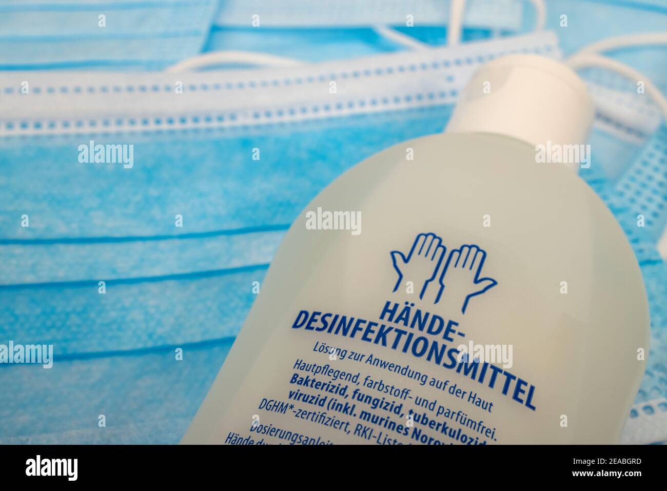 Hand disinfectant lies on blue mouth nasal protective masks, detail, symbol photo, coronavirus, Stock Photo