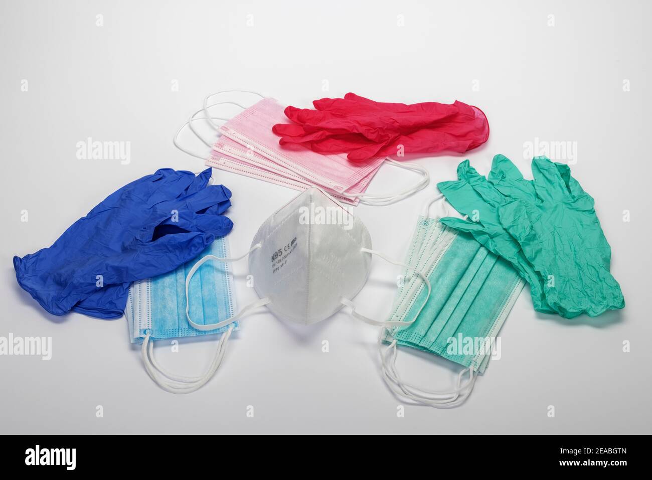 Disposable gloves, FFP2 mask, stack of blue pink and green protective mouth and nose masks, symbol photo, coronavirus, Stock Photo