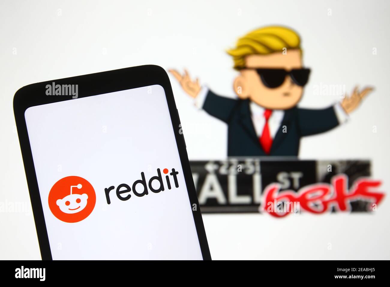 Ukraine. 08th Feb, 2021. In this photo illustration a Reddit logo is seen on a mobile phone screen in front of WallStreetBets (WSB) logo of a subreddit where participants discuss stock and options trading. Credit: SOPA Images Limited/Alamy Live News Stock Photo