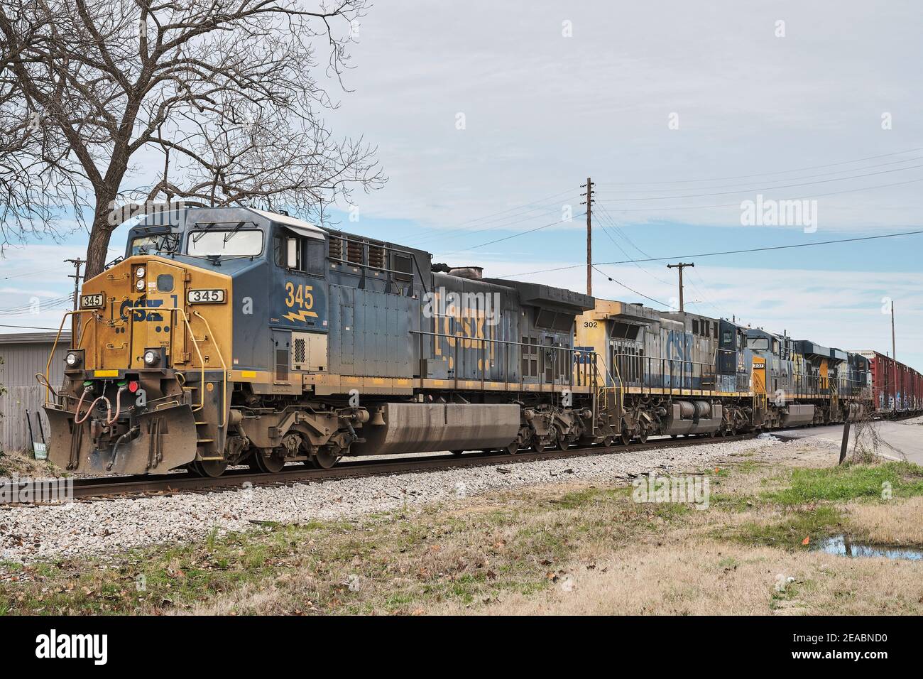 CSX Transportation #345, a GE AC44CW diesel locomotive, leads two additional locomotives pulling freight in Montgomery Alabama, USA. Stock Photo
