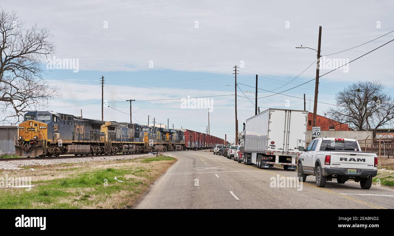 CSX railroad freight train has traffic stopped at an unguarded train crossing in Montgomery Alabama, USA. Stock Photo