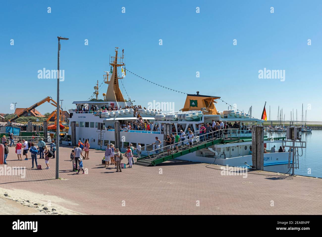 Vacationers leave the ferry 'Baltrum l' in the port of Baltrum, East Frisian island, Baltrum, Lower Saxony, Stock Photo