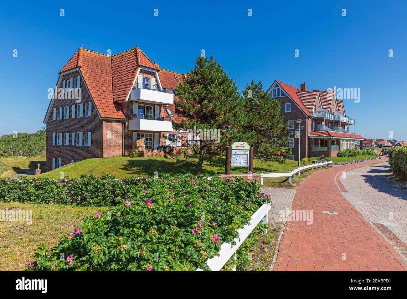 Town view, apartments 'Inselhus', behind them Hotel 'Strandhof', Westdorf, East Frisian island of Baltrum, Lower Saxony, Stock Photo