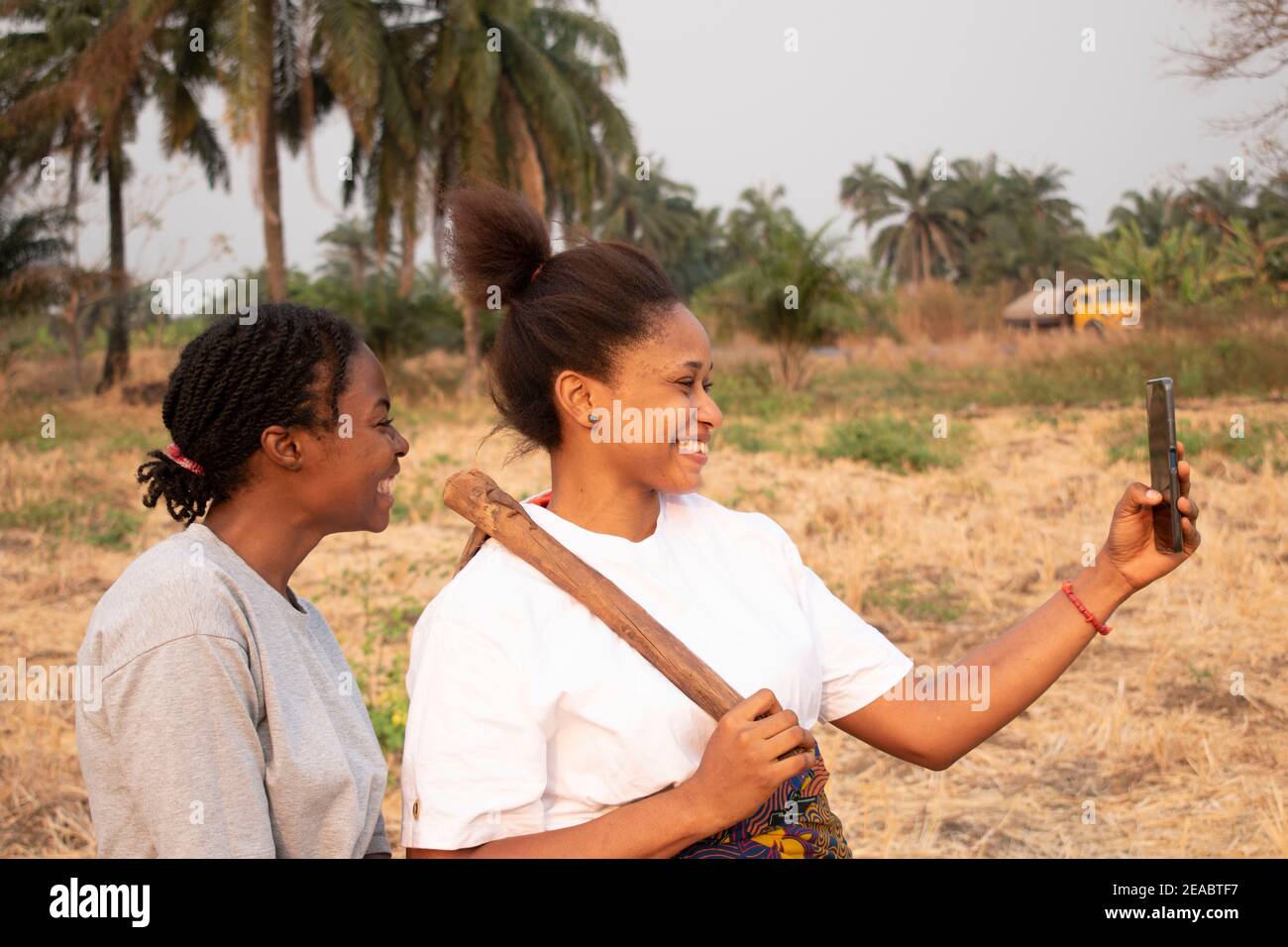 side view of two women at a farmland Stock Photo
