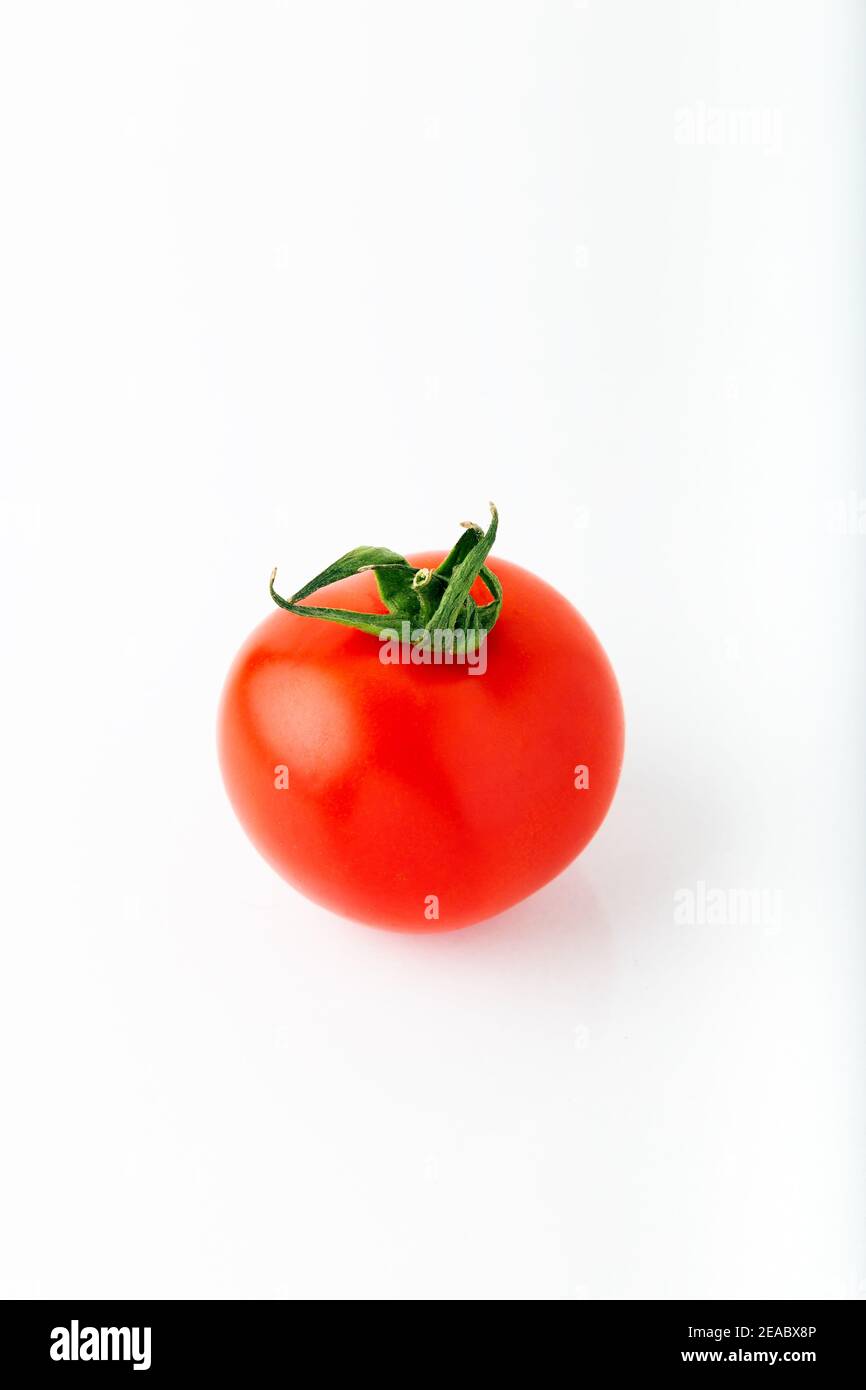 Single fresh red round tomato isolated on white background Stock Photo
