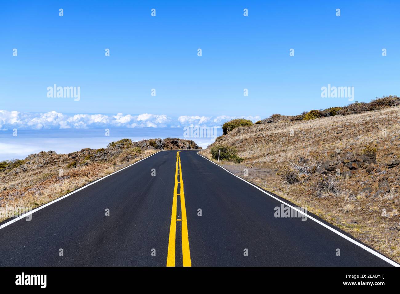 Highway in the Sky - A bright sunny day view of a newly resurfaced section of Haleakala Highway in Haleakala National Park. Maui, Hawaii, USA. Stock Photo