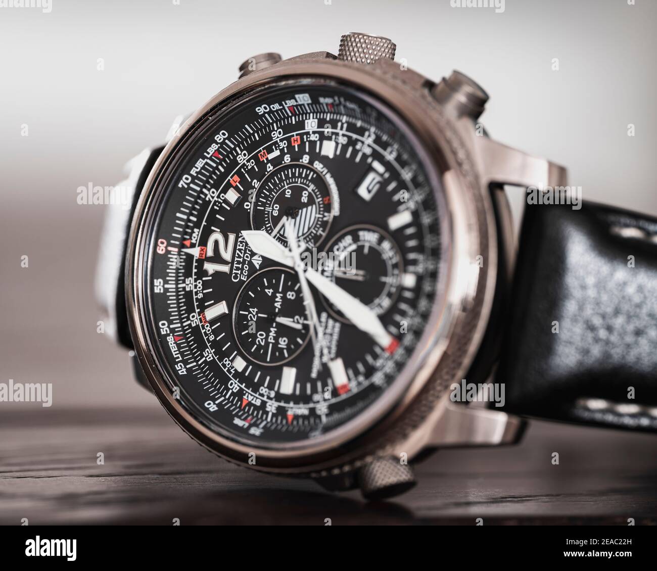 Titanium wristwatch on wooden table, close-up, chronograph, flight, automatic, leather strap Stock Photo