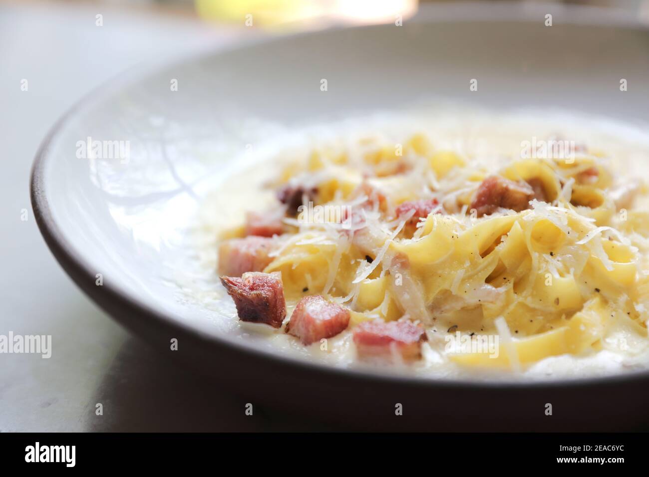 fettuccine carbonara , fettuccine pasta spaghetti with bacon ham and mushroon in white sauce italian food Stock Photo