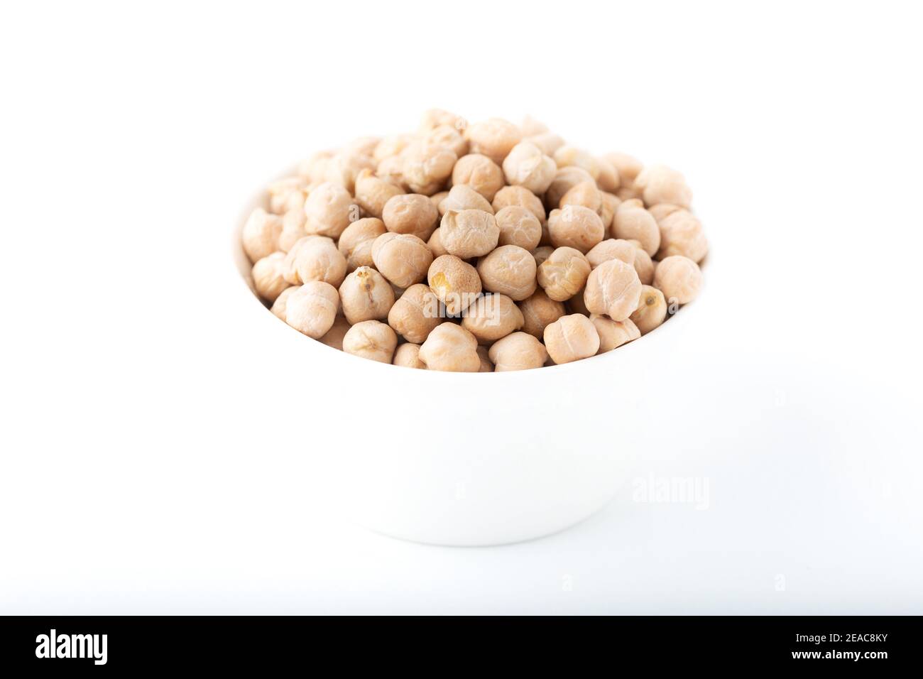 Dried chickpea beans in white bowl isolated on white background Stock