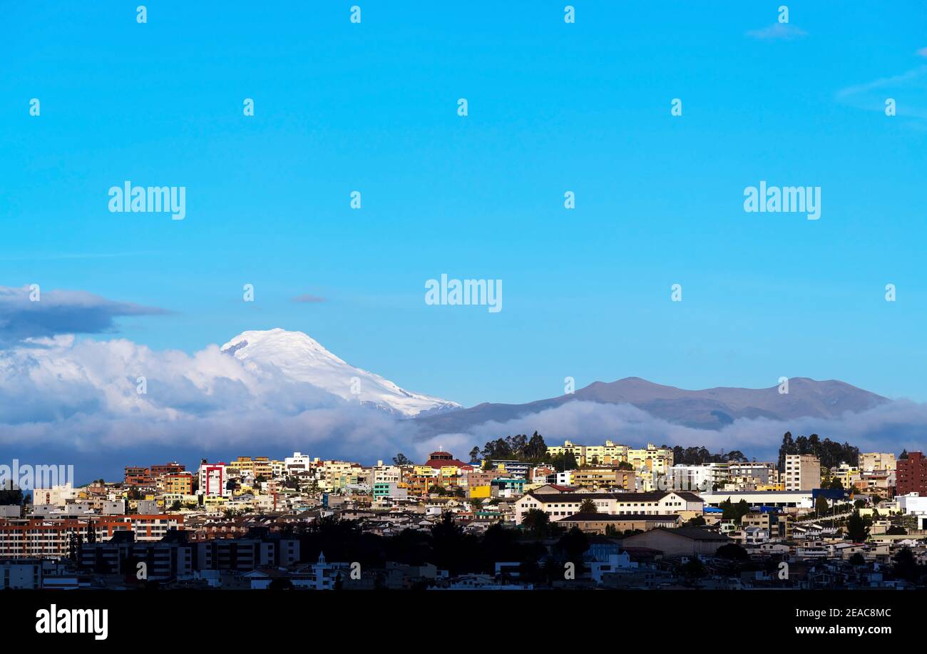 Quito aerial skyline at sunset with Cayambe volcano and copy space, Ecuador Stock Photo Alamy