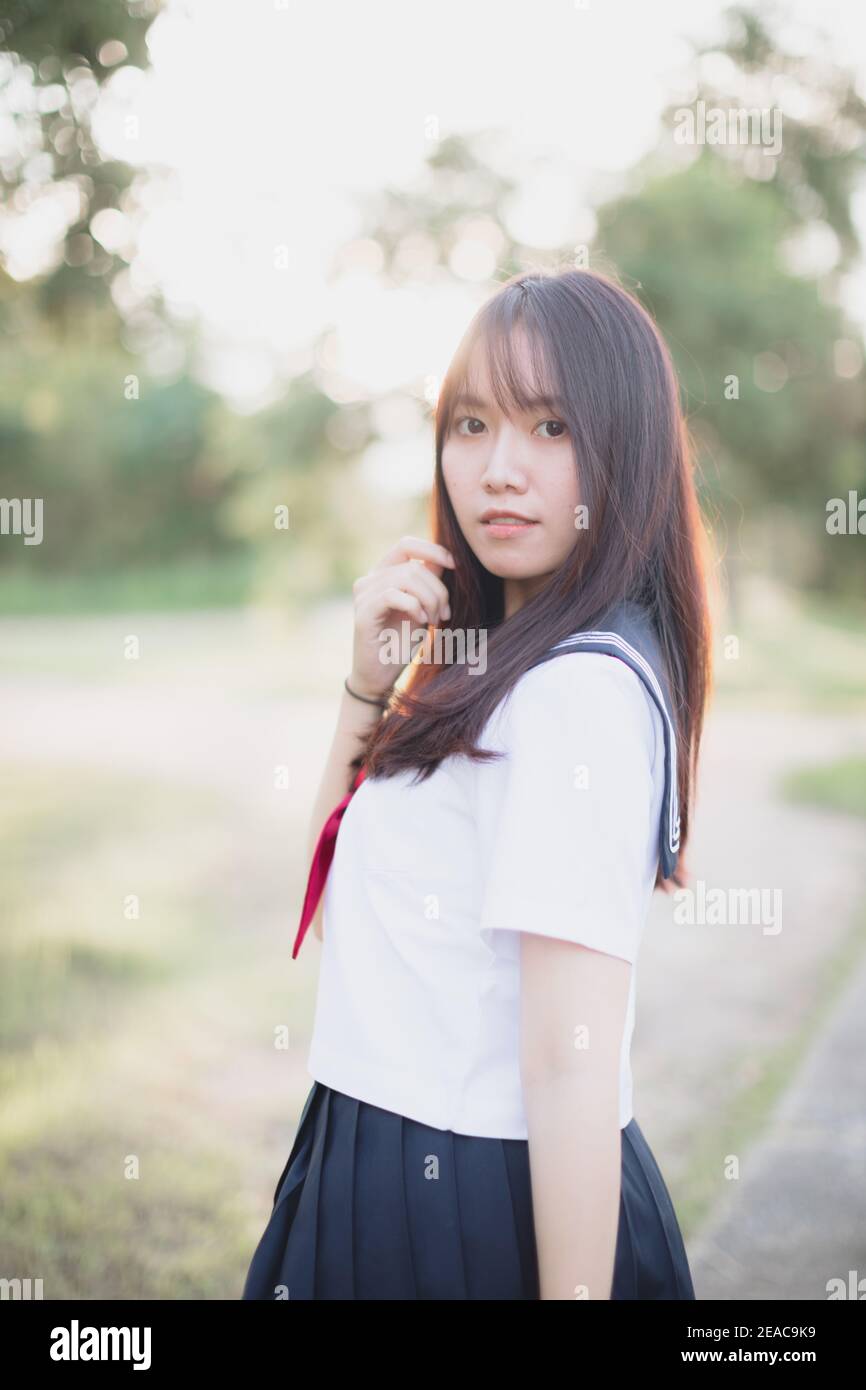 Portrait of asian japanese school girl costume looking at park outdoor
